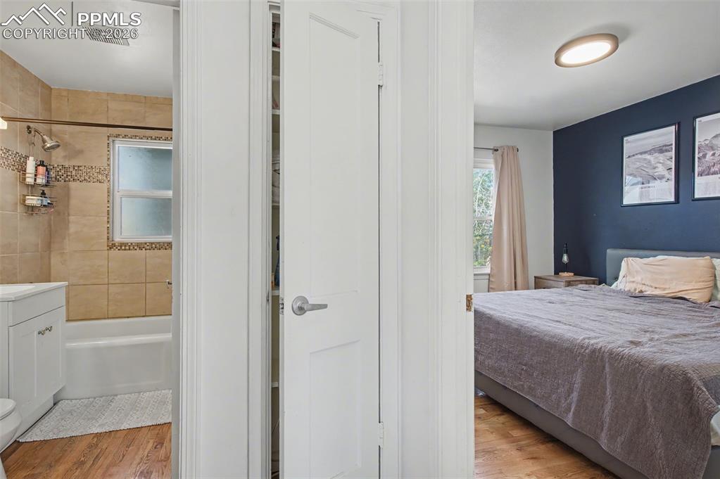 Image 14 of 28: Bedroom with light wood finished floors