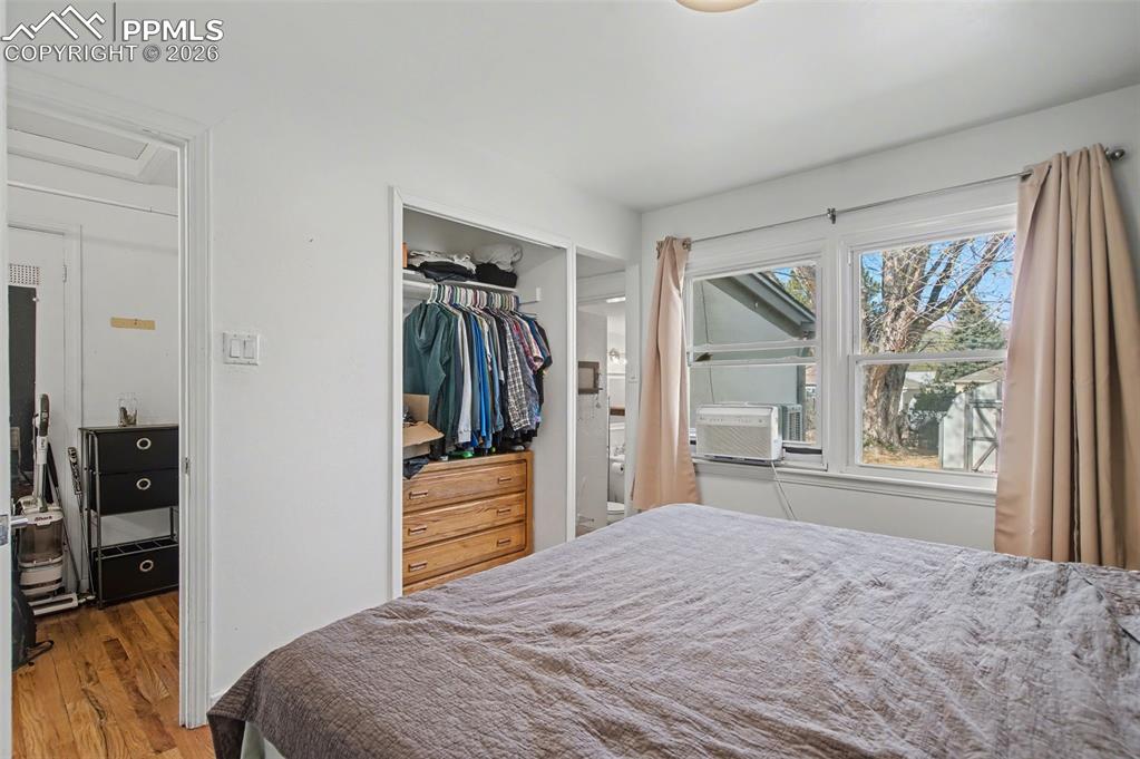 Image 16 of 28: Bedroom featuring a closet, wood finished floors, and cooling unit
