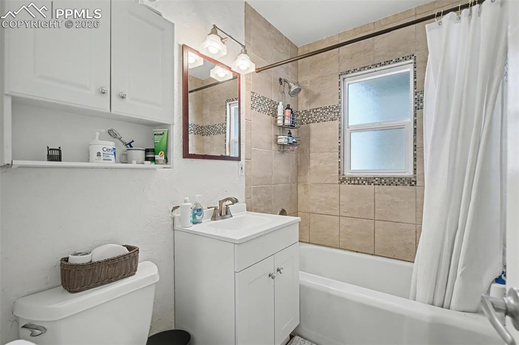 Image 18 of 28: Full bath with vanity and shower / bath combination with curtain