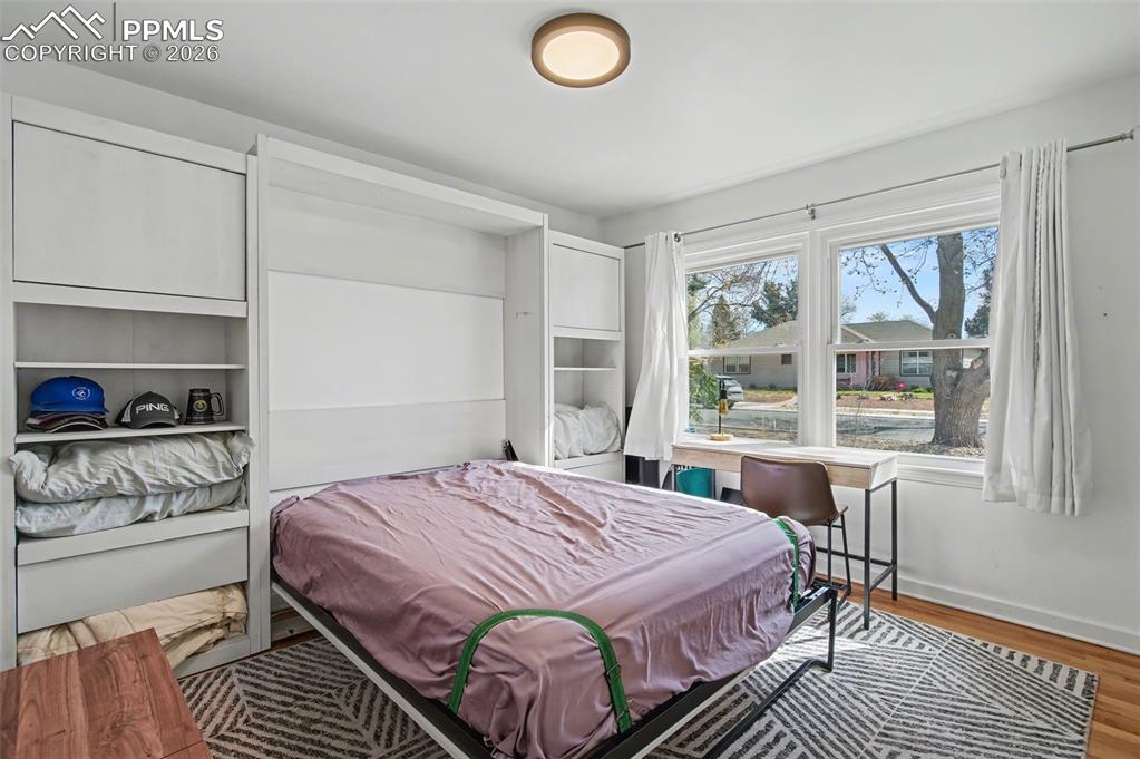 Image 21 of 28: Bedroom featuring baseboards and light wood-style floors