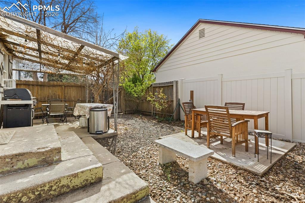 Image 25 of 28: Fenced backyard featuring outdoor dining area, a patio area, and grilling a