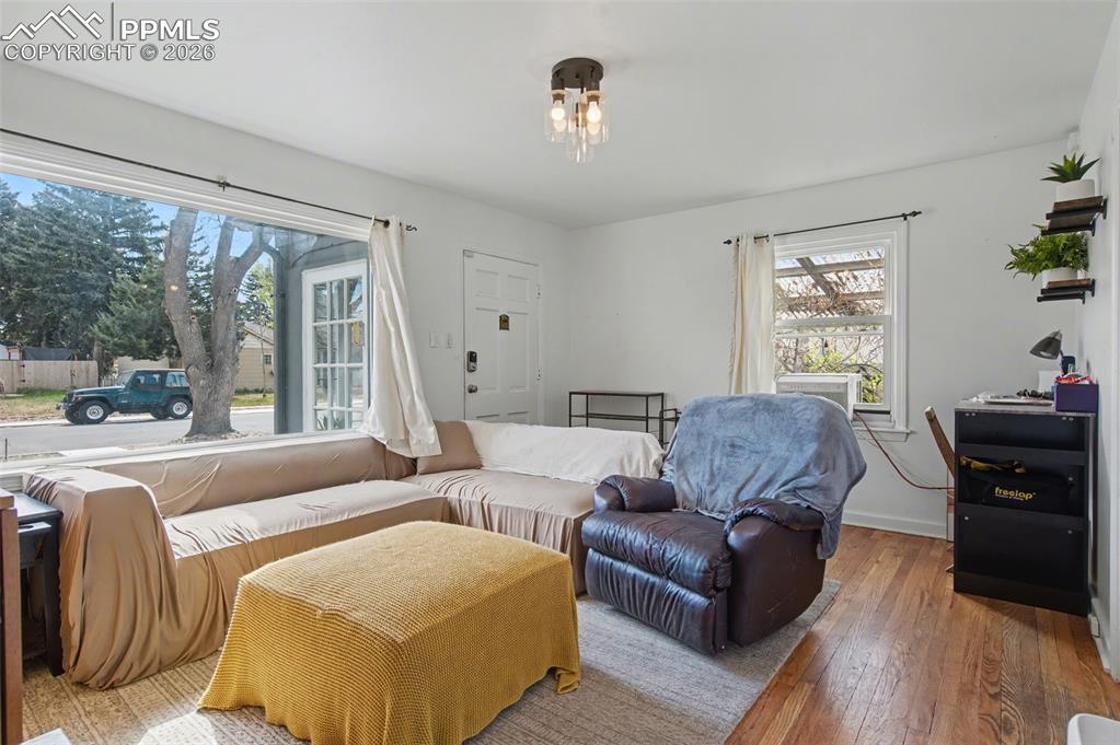 Image 5 of 28: Living area with hardwood / wood-style floors and baseboards