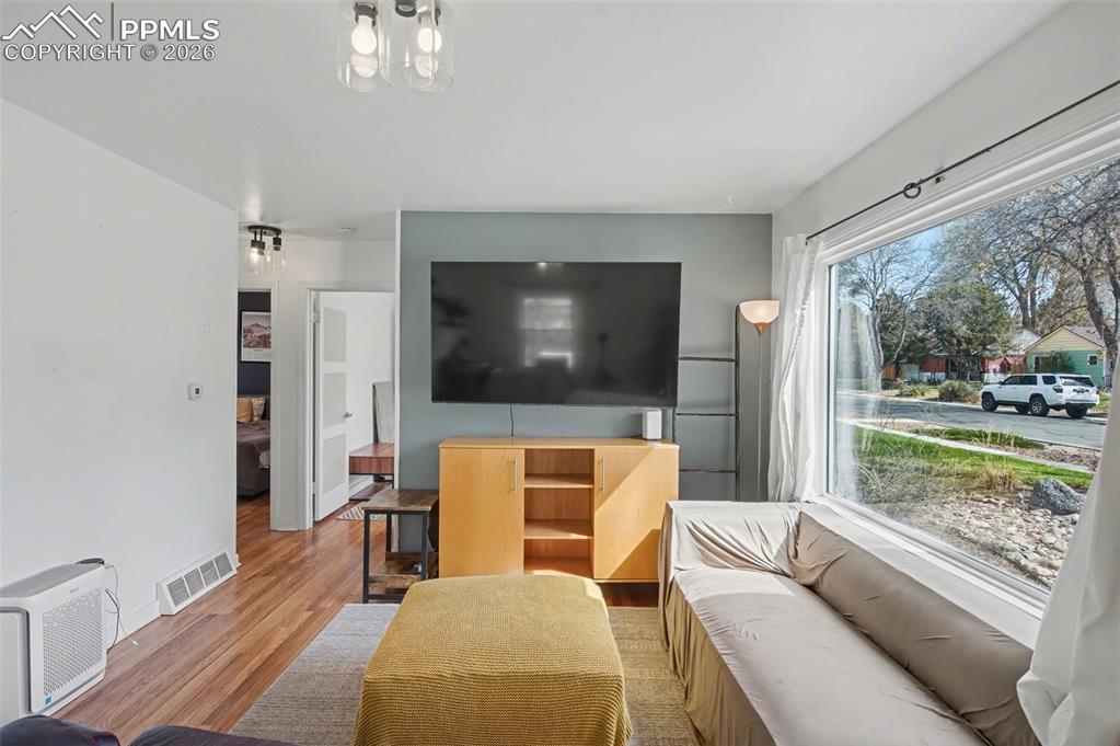 Image 6 of 28: Living room with wood finished floors and baseboards