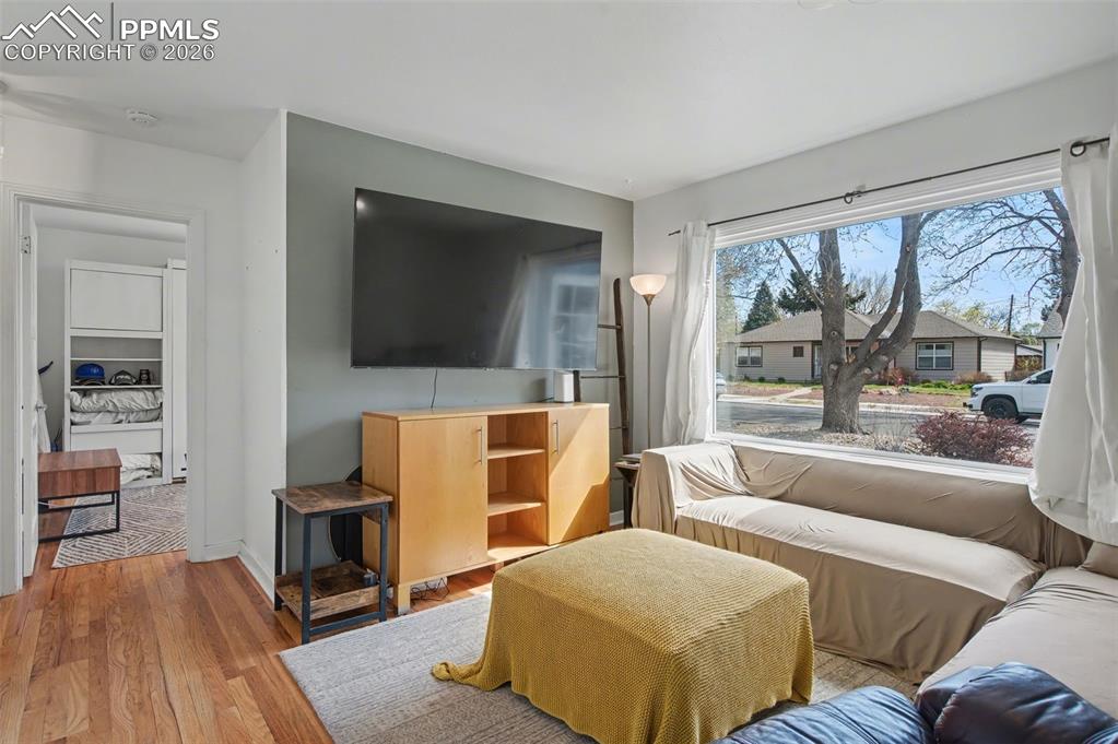 Image 8 of 28: Living room with wood finished floors and baseboards