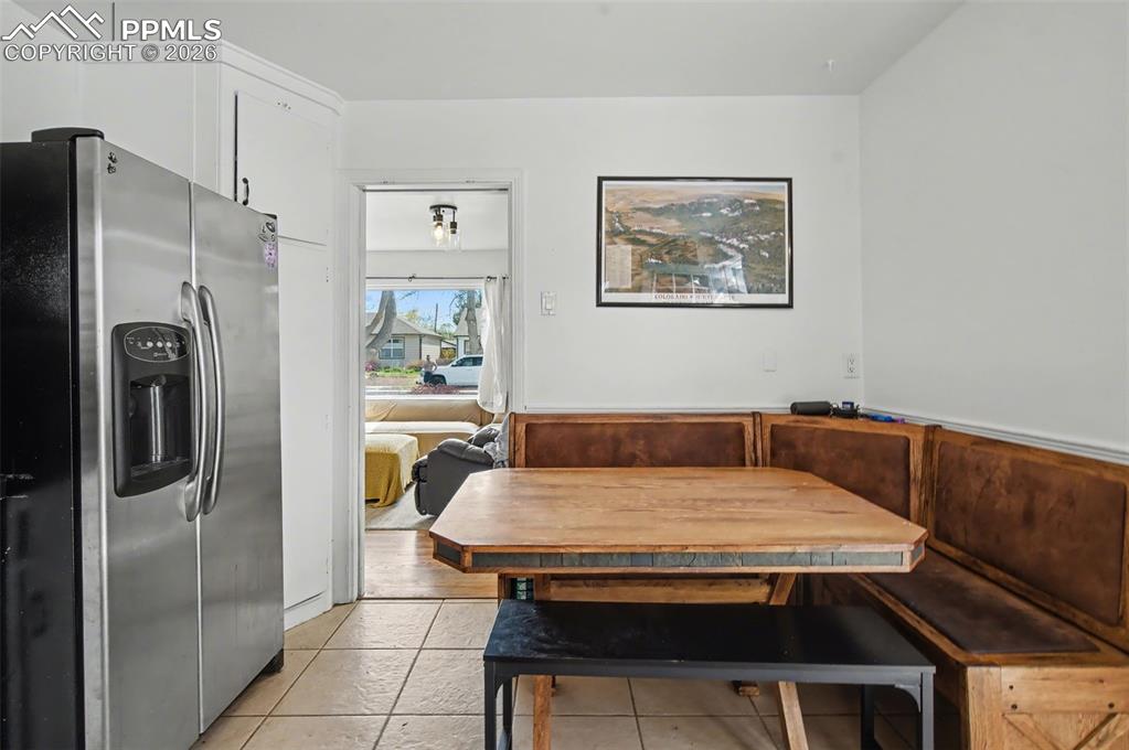 Image 9 of 28: Dining area featuring light tile patterned floors and breakfast area