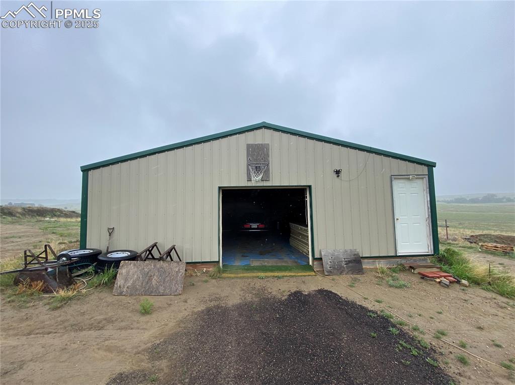 Image 33 of 48: View of pole building featuring driveway
