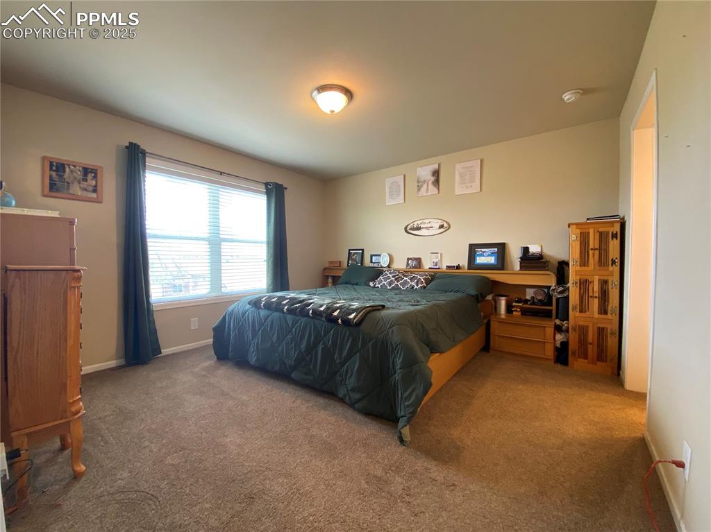 Image 8 of 48: The main level master bedroom boasts Pikes Peak views