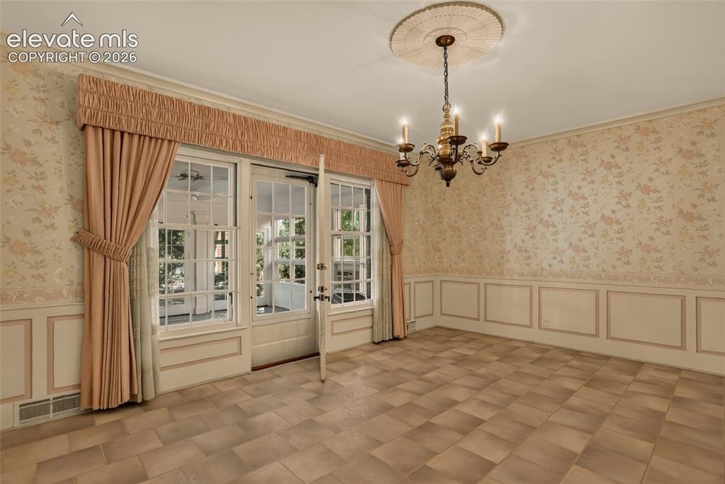 Image 13 of 49: Formal dining room, with view into foyer and kitchen.