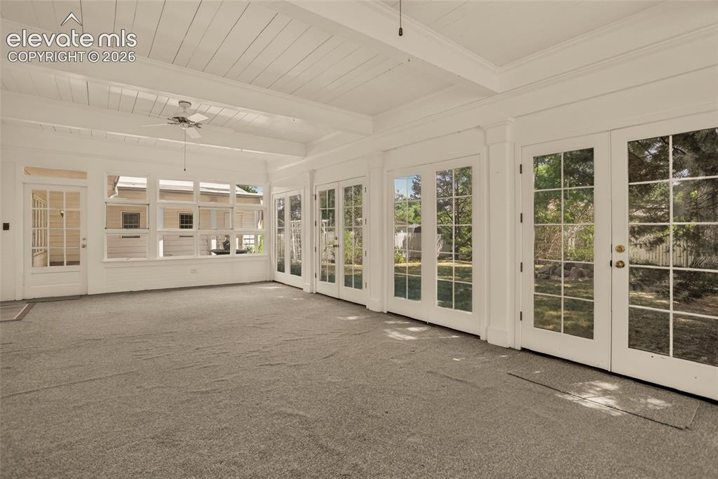 Image 14 of 49: Formal dining room, with door to sunroom.