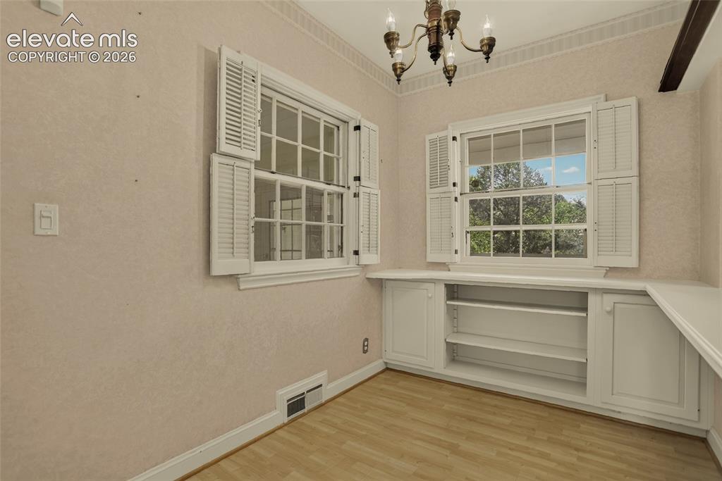 Image 20 of 49: Kitchen, and view of breakfast nook and mudroom beyond.