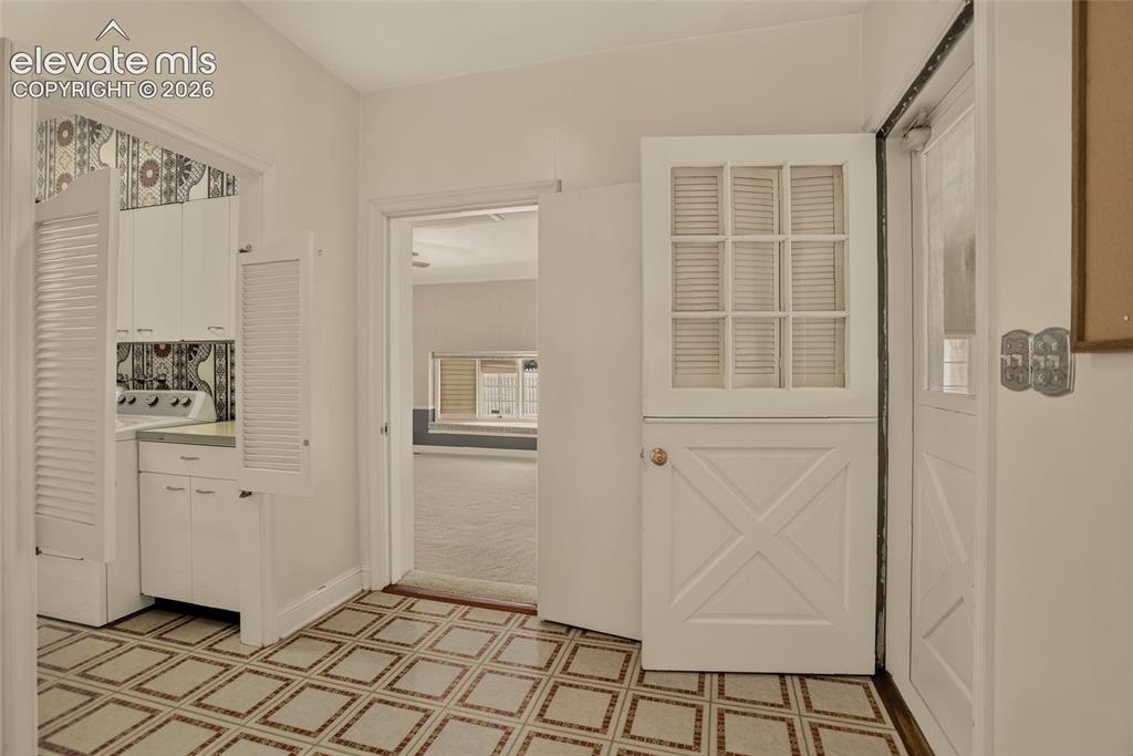 Image 35 of 49: Family room with door to bsmt. rec. room and breezeway, and view of mudroom