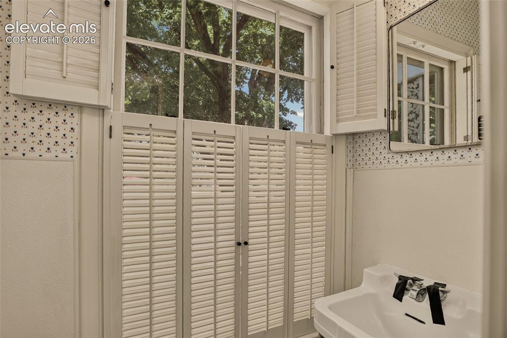 Image 37 of 49: Laundry, with 2nd powder bath beyond.