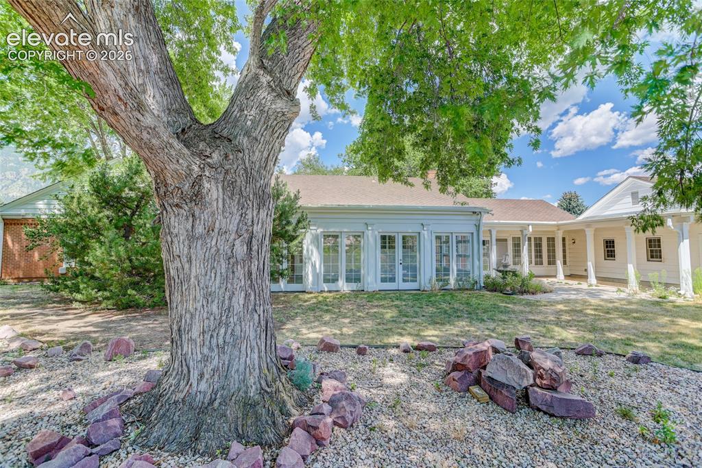 Image 46 of 49: Back of house and view of sunroom.