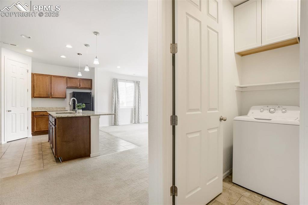 Image 13 of 36: Laundry room with washer / clothes dryer, recessed lighting, light tile pat