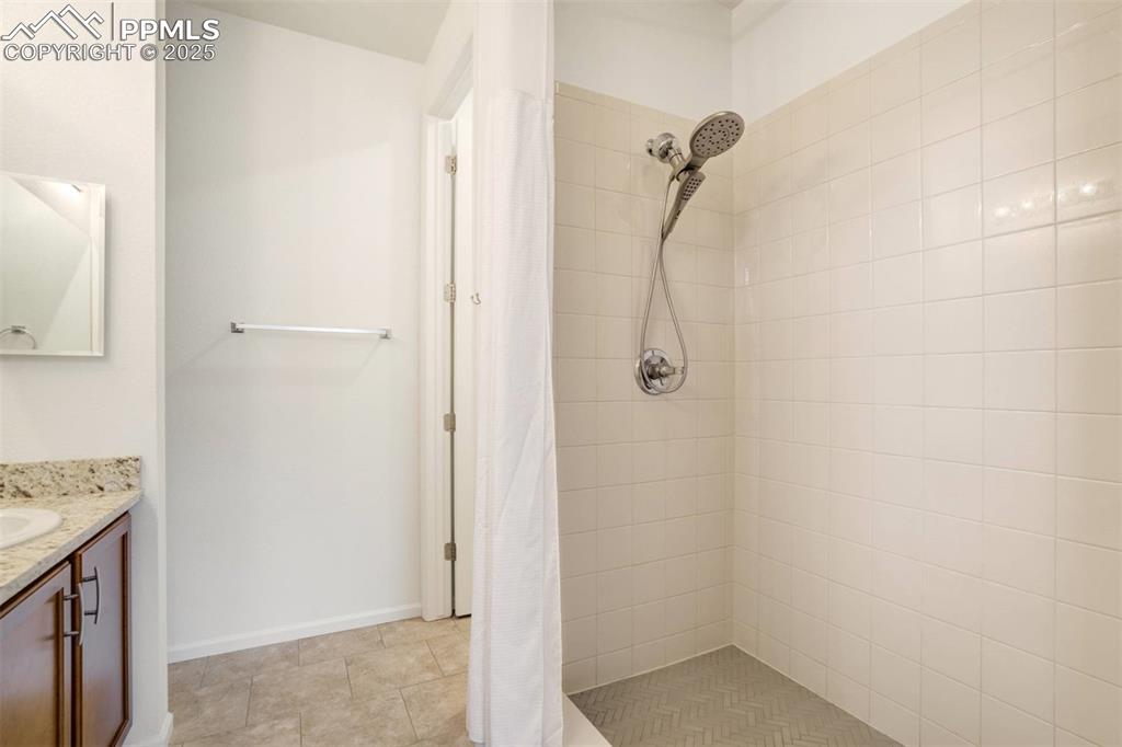 Image 20 of 36: Full bath featuring vanity and tiled shower