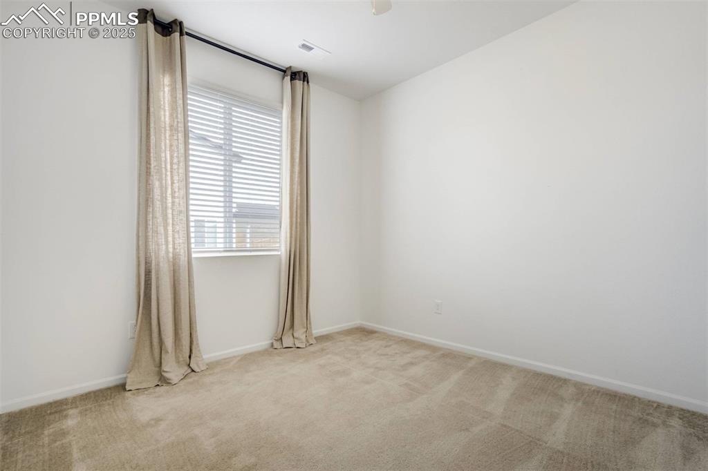 Image 27 of 36: Carpeted empty room with baseboards