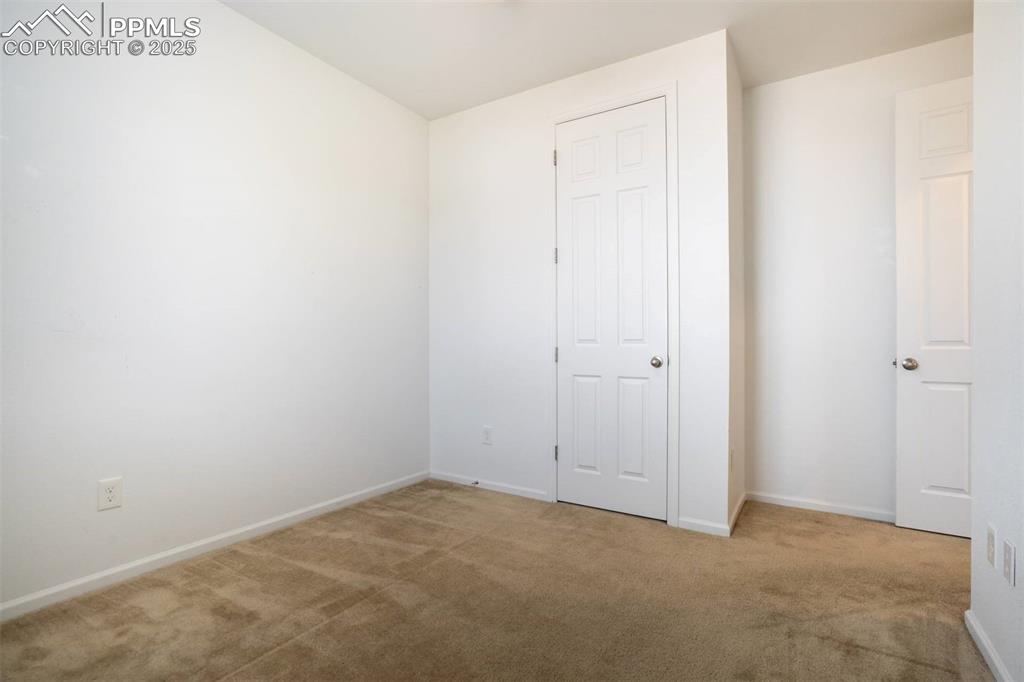 Image 28 of 36: Unfurnished bedroom with carpet floors