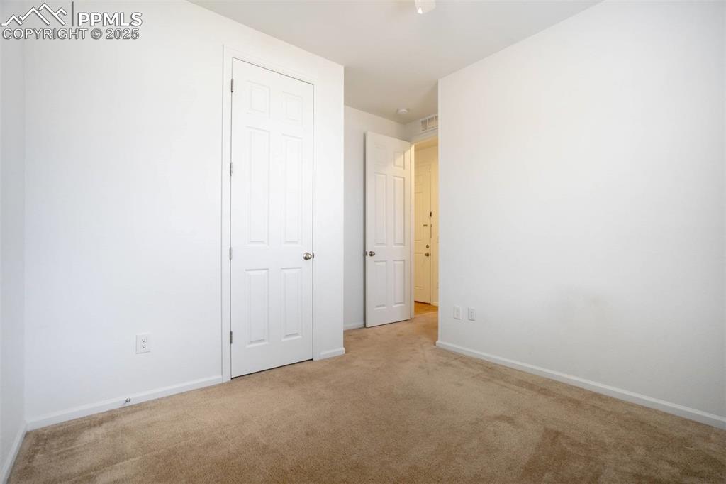 Image 29 of 36: Unfurnished bedroom with carpet floors and baseboards