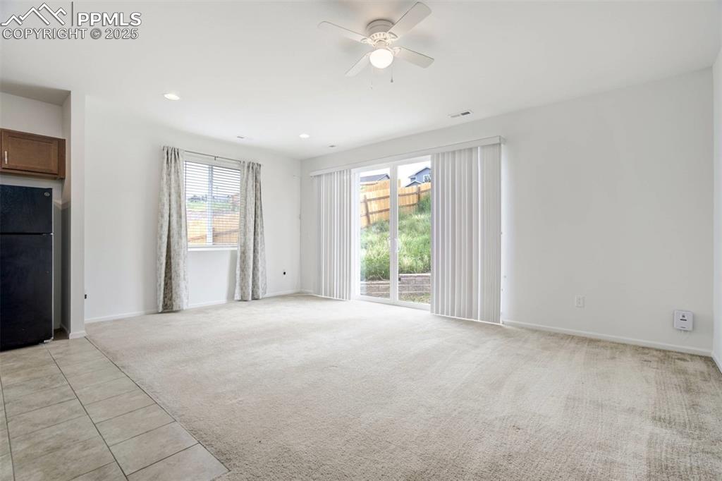 Image 3 of 36: Unfurnished living room with light carpet, a ceiling fan, and recessed ligh