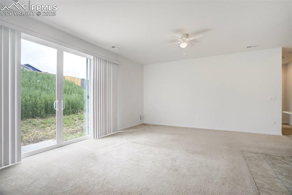 Image 7 of 36: Spare room featuring light colored carpet and ceiling fan