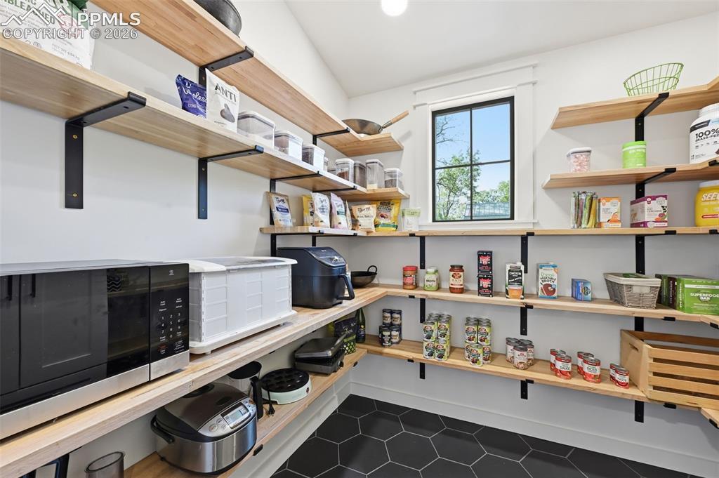Image 12 of 50: Walk-in pantry with natural light and heated floors.