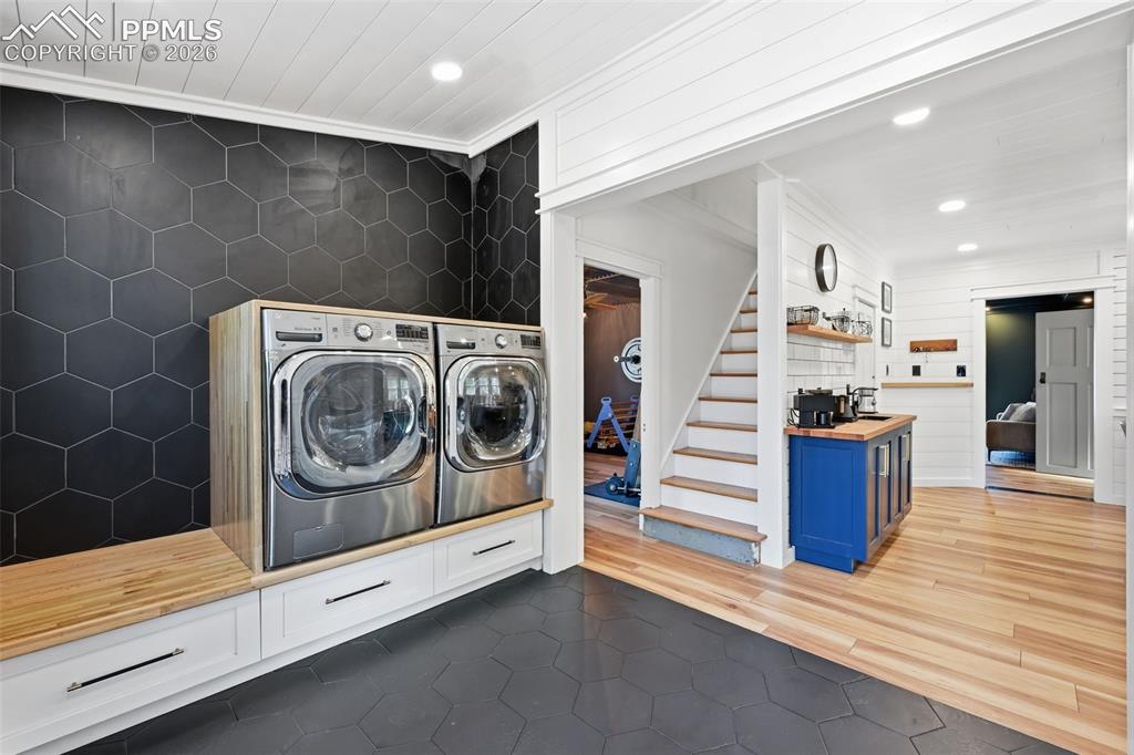 Image 16 of 50: Both the laundry space and pantry offer heated tile floors