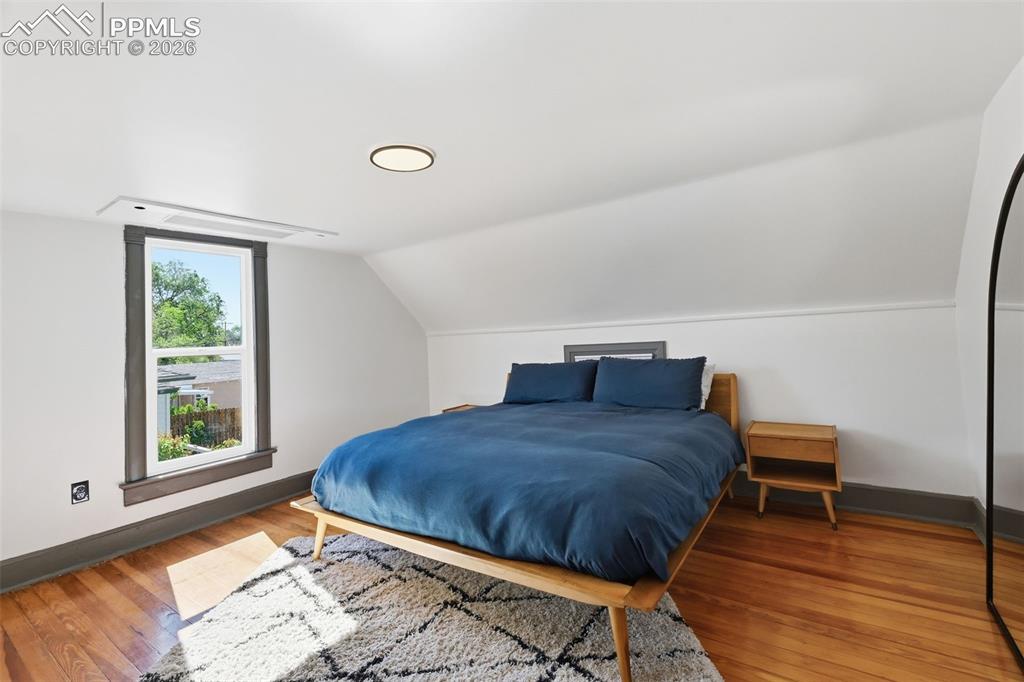 Image 17 of 50: Primary suite hosts original hardwood floors, and a private 3/4 bath.