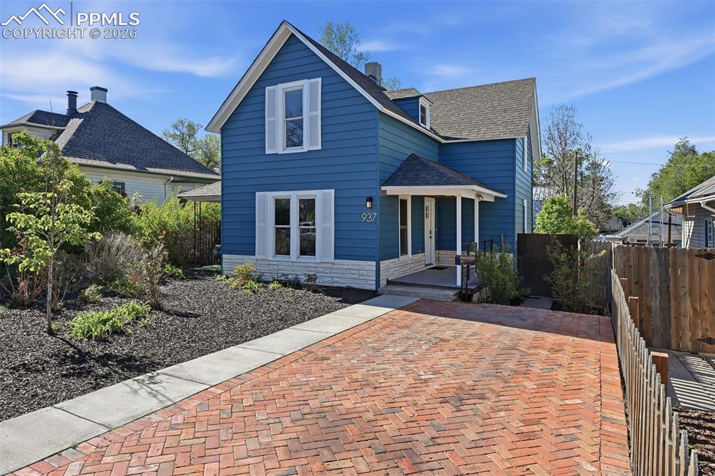 Image 2 of 50: Intricate brick driveway pairs perfectly with the newly painted home.