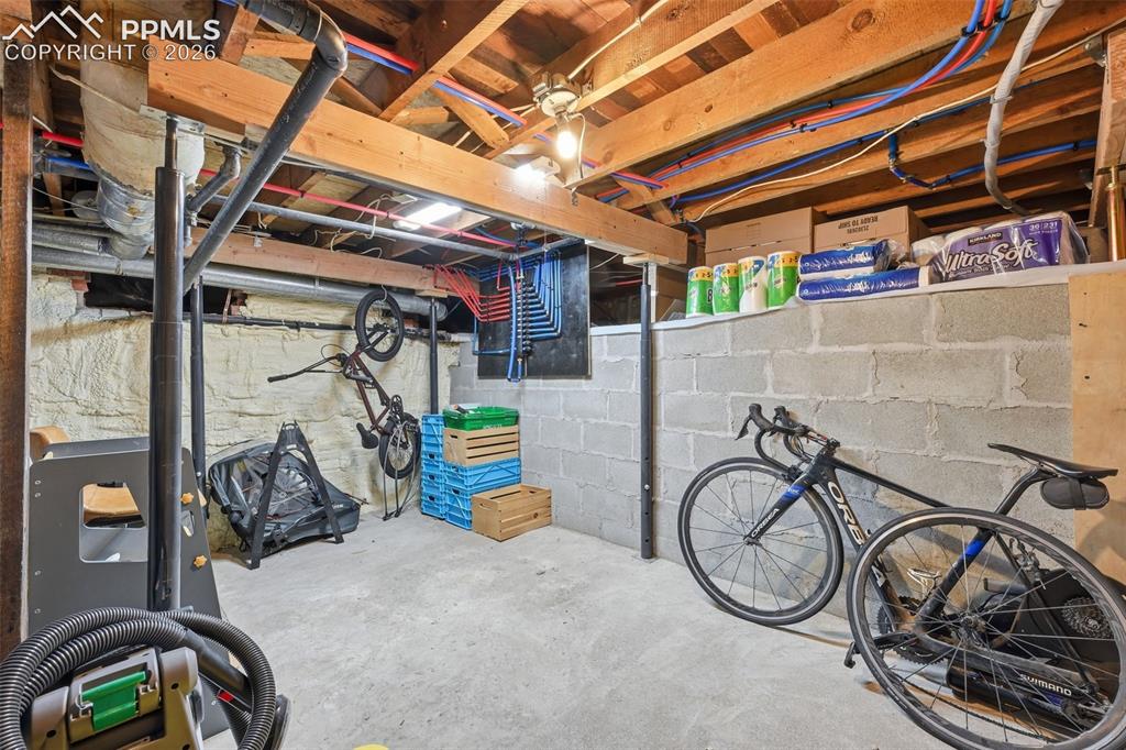 Image 22 of 50: Unfinished basement / utility room offers ample room for storage.