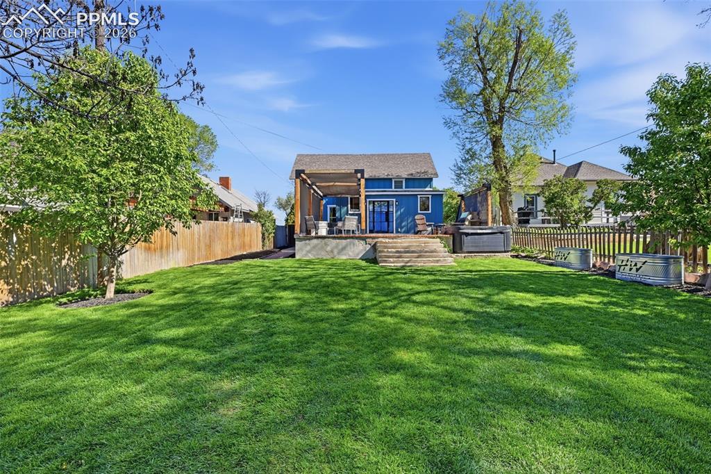 Image 29 of 50: This property has drought-tolerant landscaping in the front, and lush green
