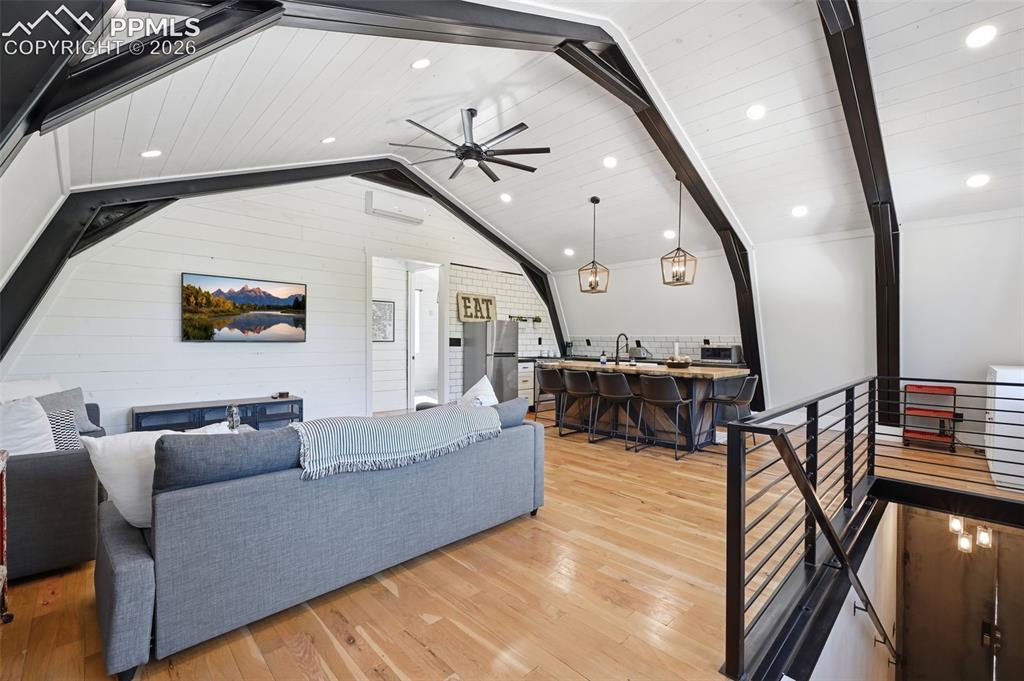 Image 36 of 50: Apartment living room features oak hardwood floors and soaring ceilings.