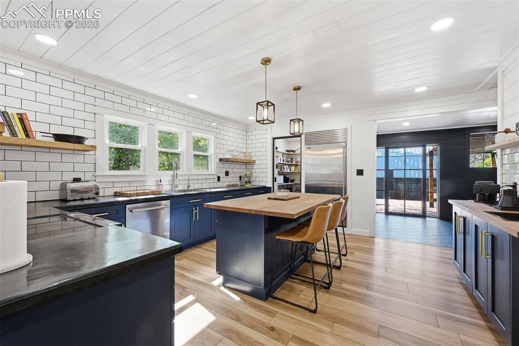 Image 9 of 50: Perfectly placed island offers breakfast seating and a perfect location for
