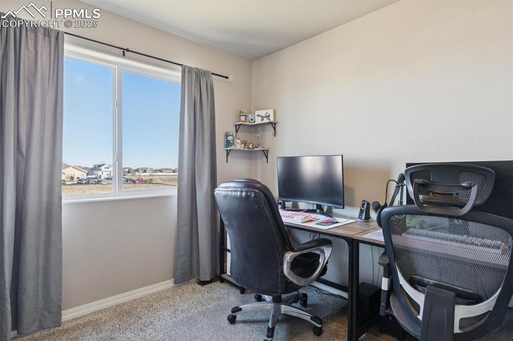 Image 12 of 45: Office space with baseboards and light colored carpet