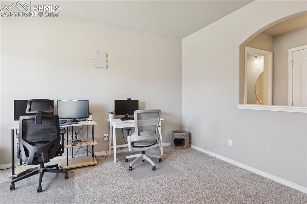 Image 13 of 45: Carpeted home office featuring baseboards