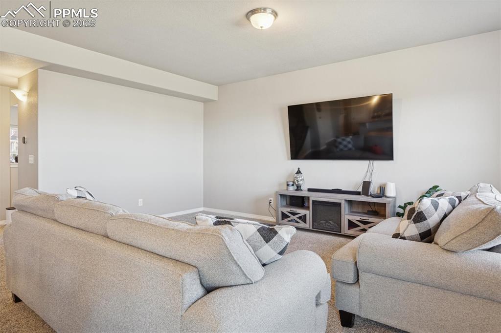 Image 16 of 45: Carpeted living area with baseboards