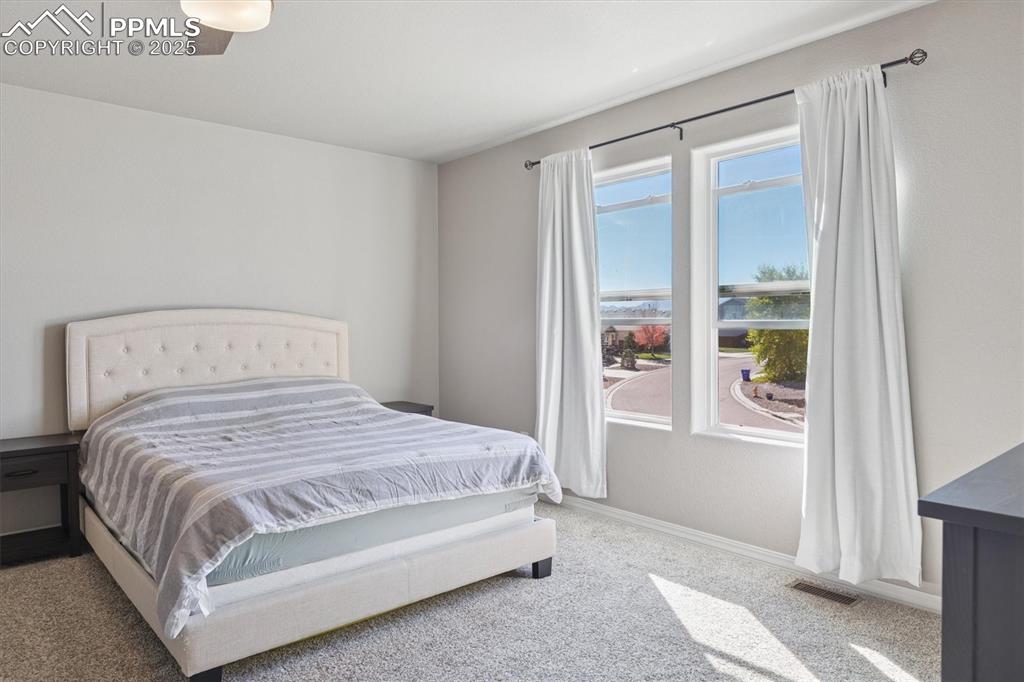 Image 27 of 45: Bedroom featuring light colored carpet and ceiling fan