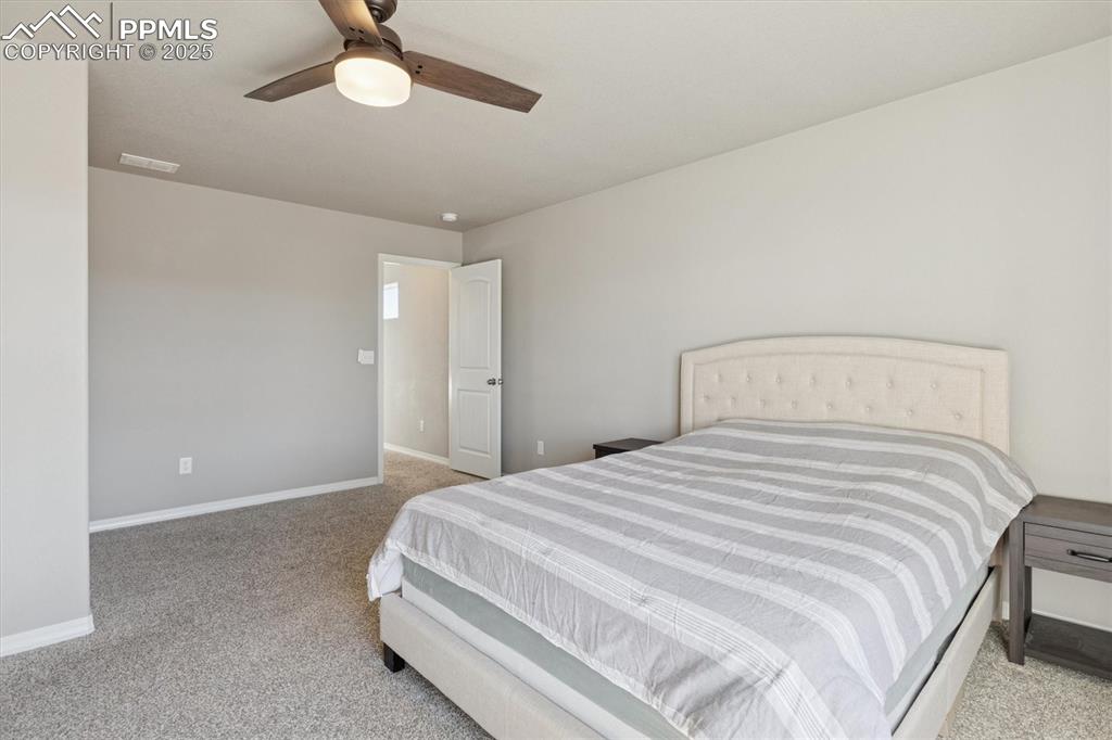 Image 29 of 45: Bedroom featuring light colored carpet and a ceiling fan