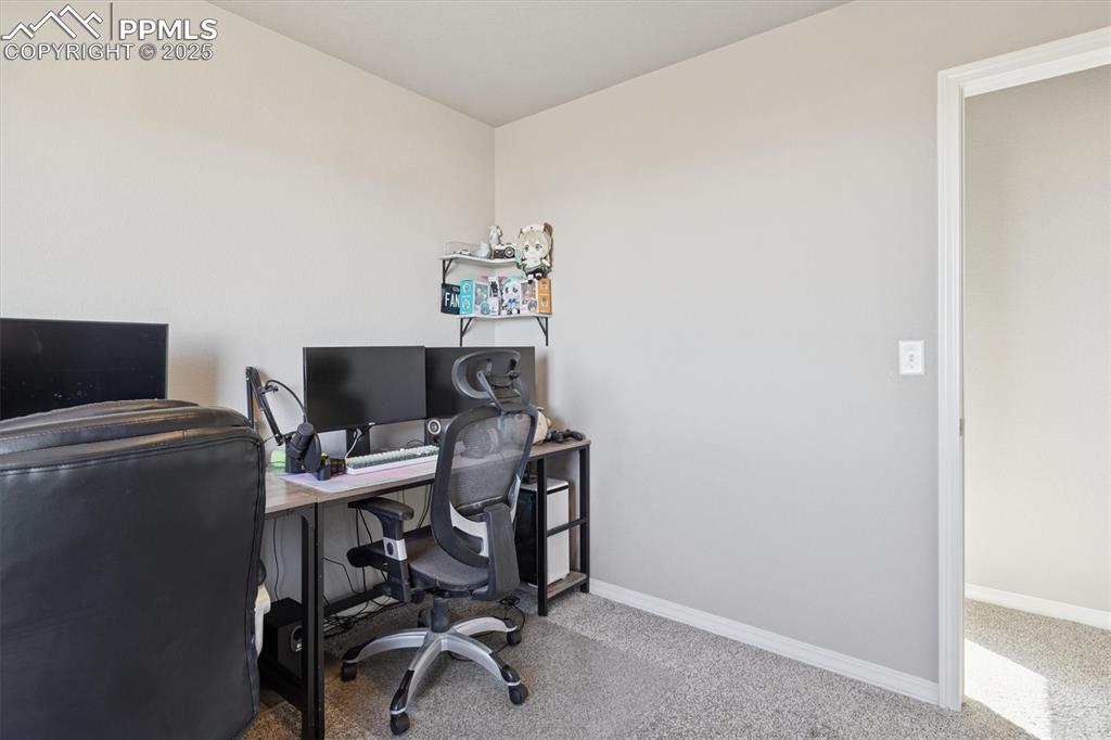 Image 41 of 45: Carpeted office space with baseboards