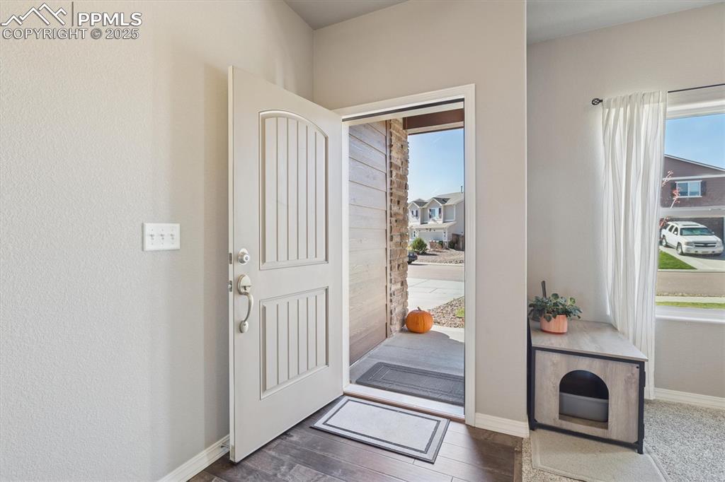 Image 7 of 45: Foyer entrance featuring baseboards and dark wood-type flooring