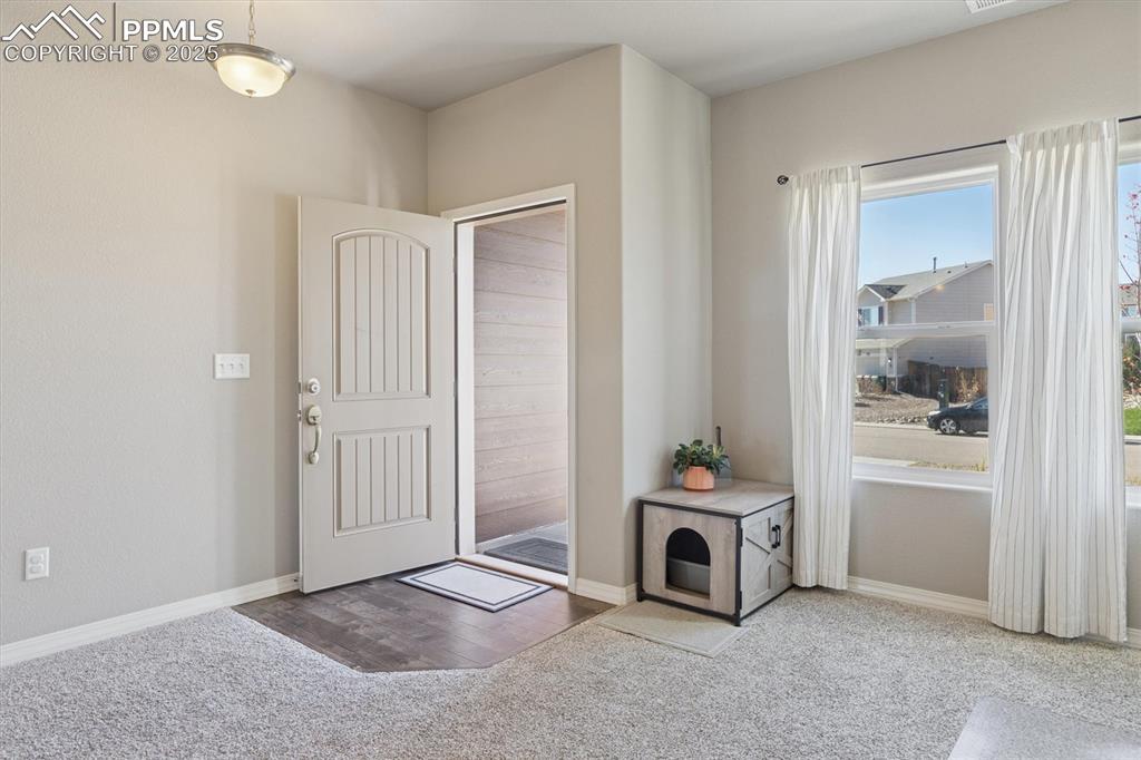Image 8 of 45: Entryway featuring light colored carpet and light wood finished floors