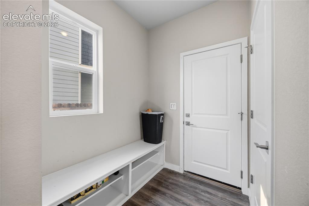 Image 15 of 45: Mud Room with seated bench and garage access.