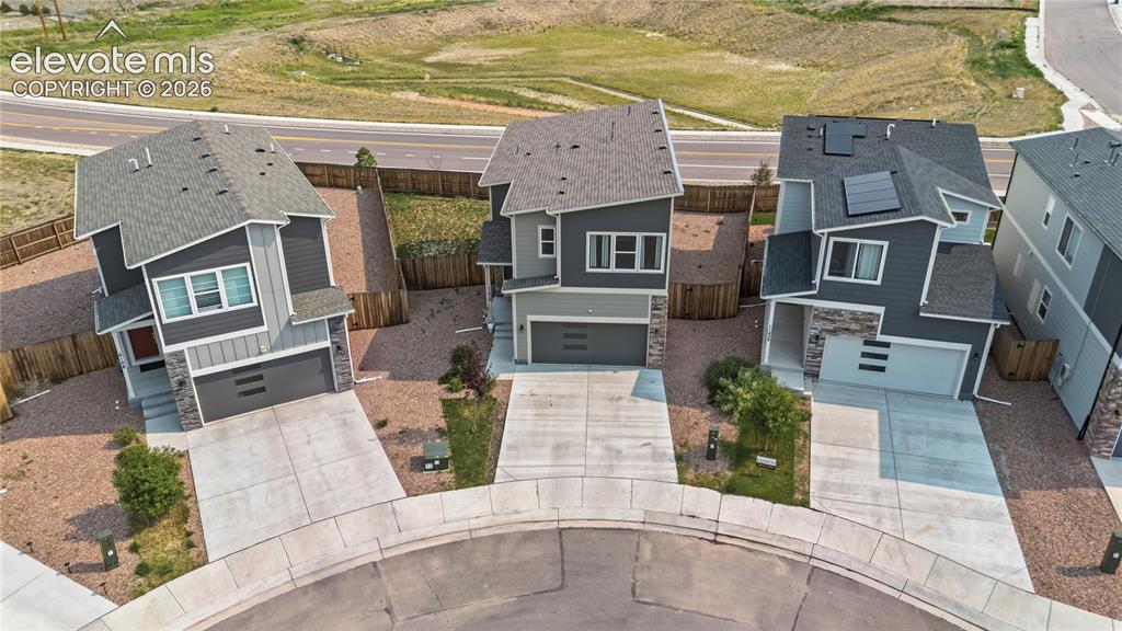 Image 2 of 45: Aerial view of home that backs to open space with walking trails.