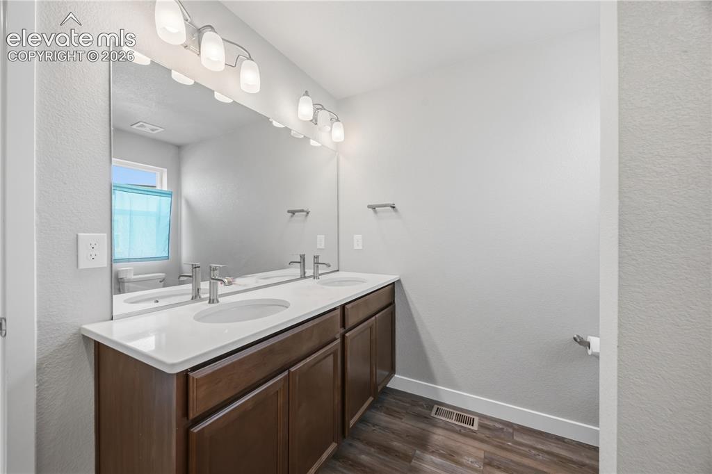 Image 31 of 45: Comfort height, dual sink vanity and mirror in the upper level Hall Bathroo