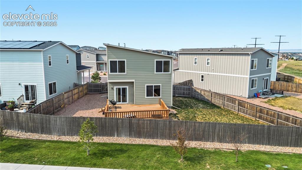 Image 39 of 45: Aerial rear view of home and fenced backyard.
