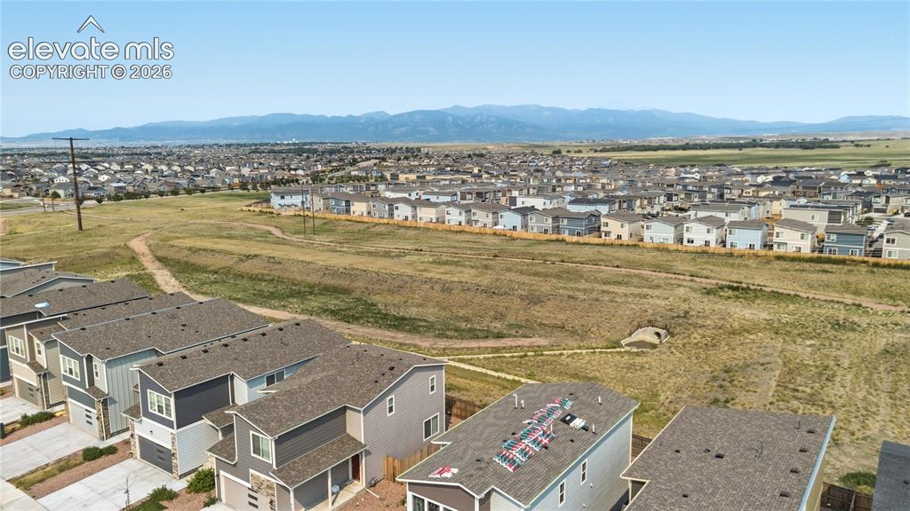 Image 41 of 45: Open space with walking trails and mountain views.