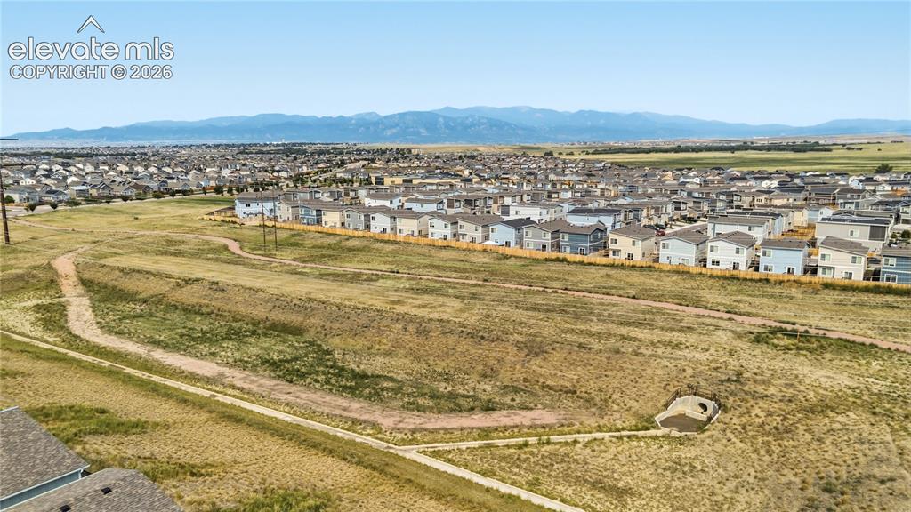 Image 42 of 45: Open space with walking tails and mountain views.