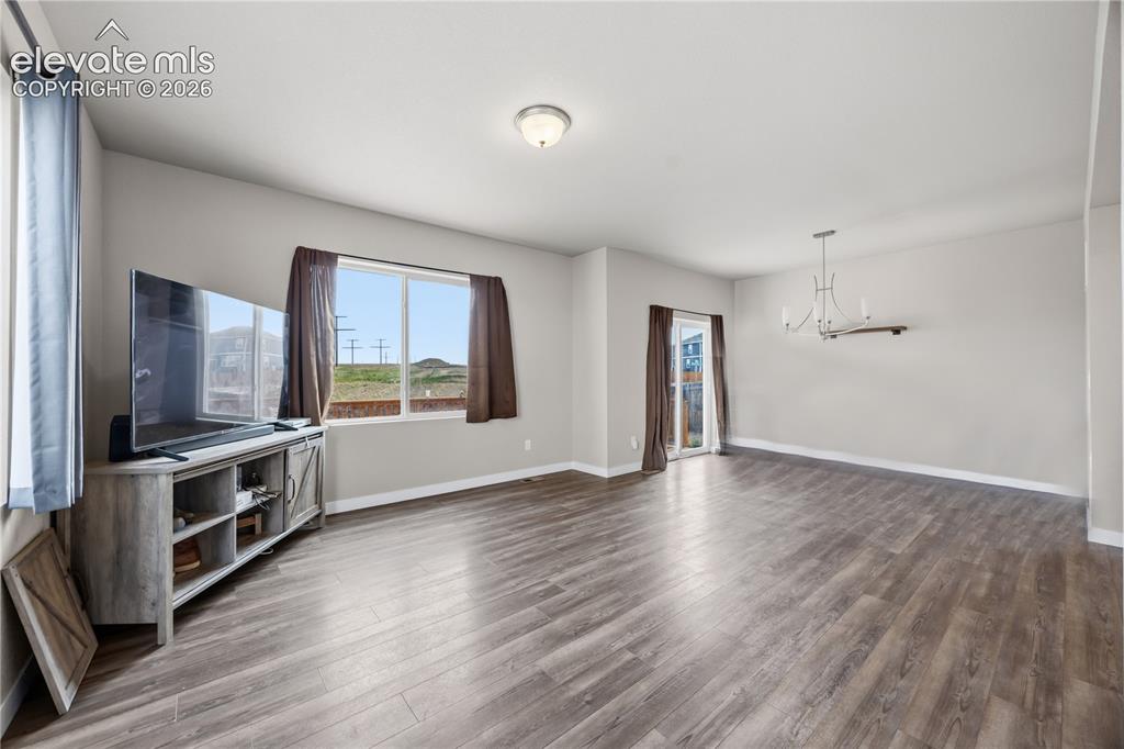 Image 6 of 45: Beautiful luxury vinyl plank floors throughout the main level.