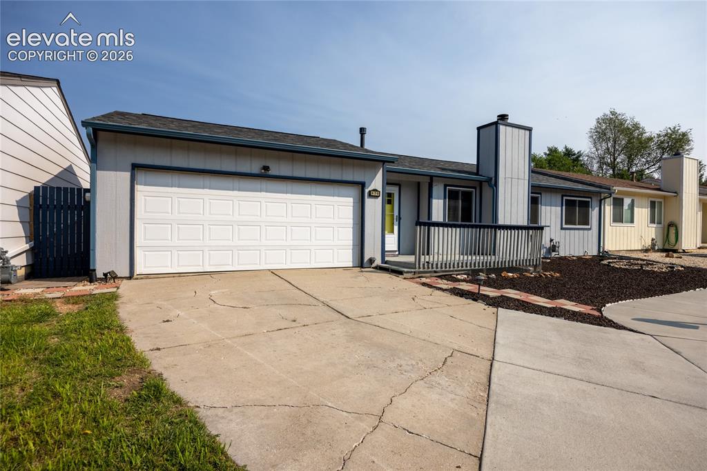 Image 3 of 26: Attached front-facing garage with a paneled door