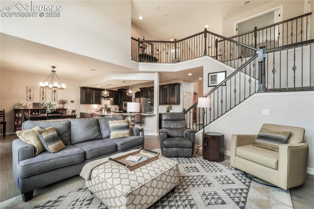 Image 18 of 50: Living room with vaulted ceilings and gas fireplace