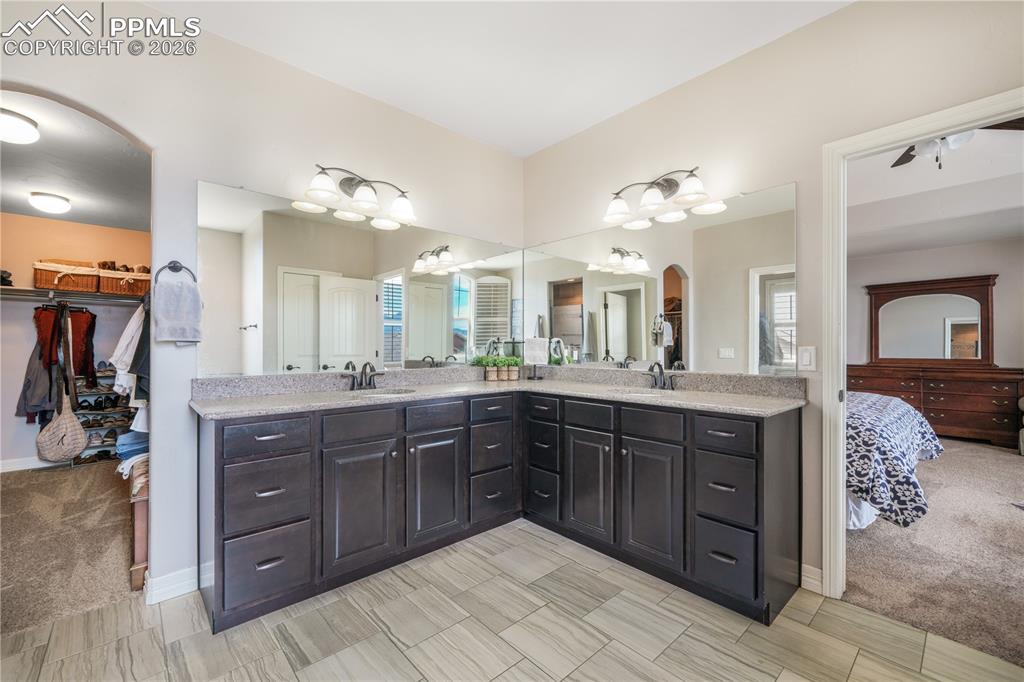 Image 28 of 50: Upper level primary bedroom with sitting area, 5 piece bath with dual vanit